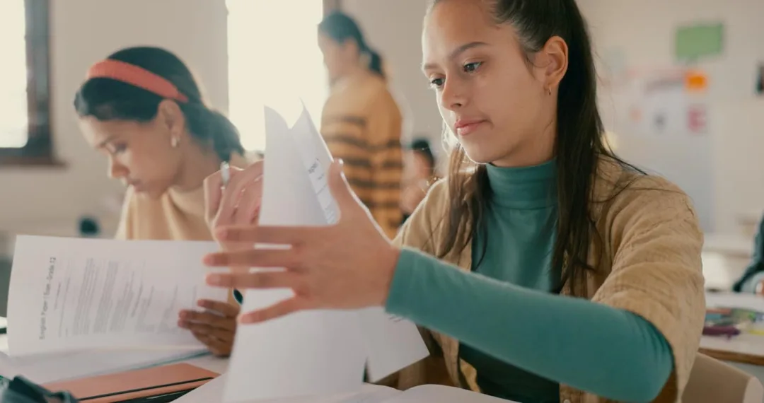 A girl learning about k 12 curriculum in a paper.
