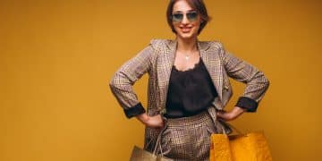 Woman with shopping bags in studio on yellow background isolated
